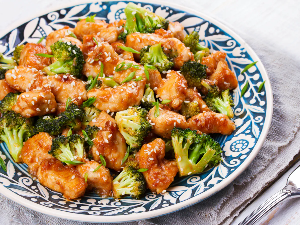 Glazed sesame chicken stir-fried with crisp broccoli florets